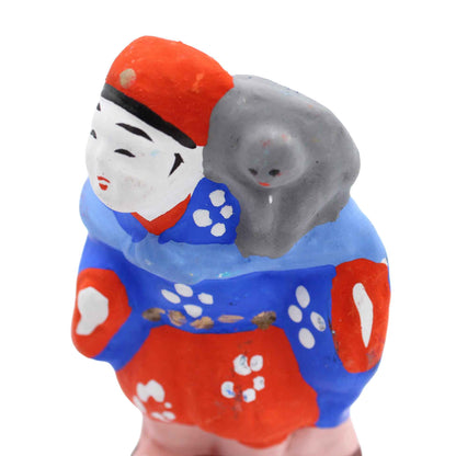 Clay doll street performance with monkey