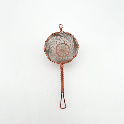 Kyoto handcrafted single-cup copper tea strainer resting on a modern ceramic mug